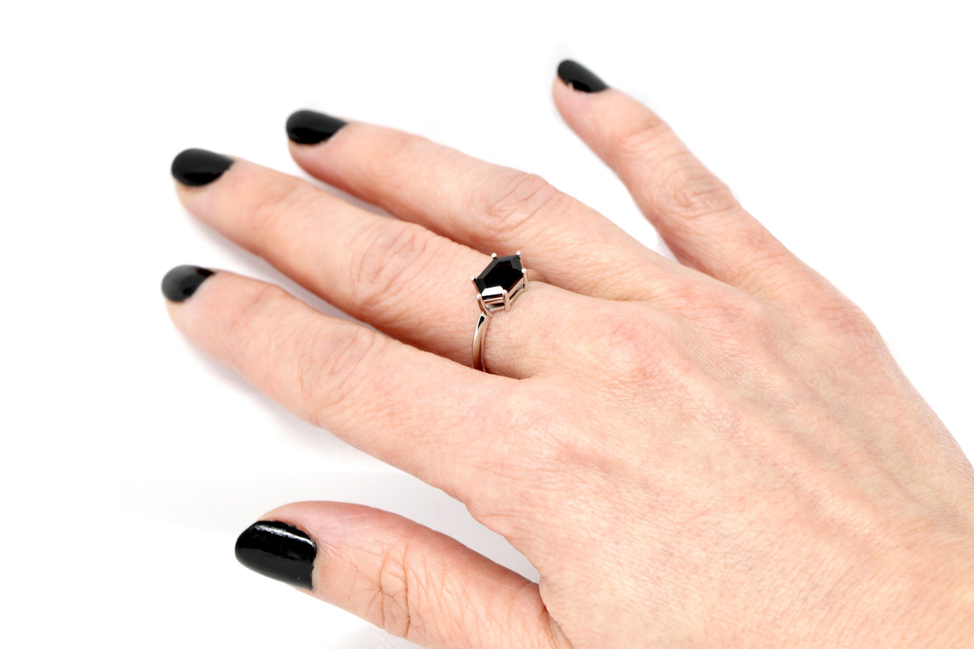 Girl wearing a hexagonal black gemstone ring custom made in montreal fine jewelry signature design edgy style custom bridal jewelry designer bena jewelry montreal made in canada simple modern color gemstone engagement ring