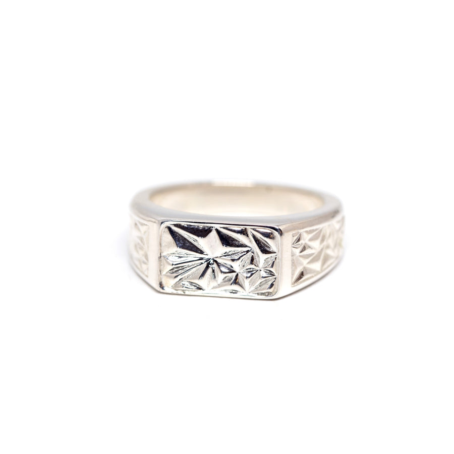 front view of a silver signet ring with a pyramidal texture made in montreal ruby mardi jewelry designer on a white background