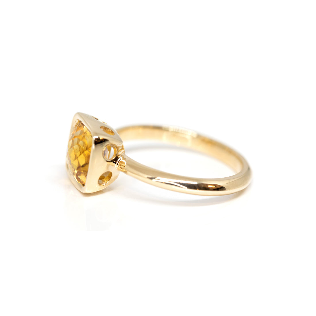 side view of yellow gold bezel setting citrine ring made in montreal by bena jewelry on a white background