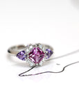side view square pink and purple sapphire and diamond platimum ring custom made jewels in bena jewelry on white background