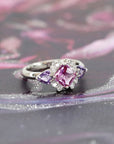 cusotm made purple sapphire ring custom made platinium ring with purple trillion gems and diamond bridal ring on multi color background