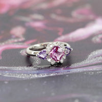 cusotm made purple sapphire ring custom made platinium ring with purple trillion gems and diamond bridal ring on multi color background