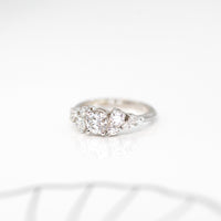 side view of round diamond engagement ring in white gold made whit few extra bright diamonds custom made in montreal by bena jewelry on a white background