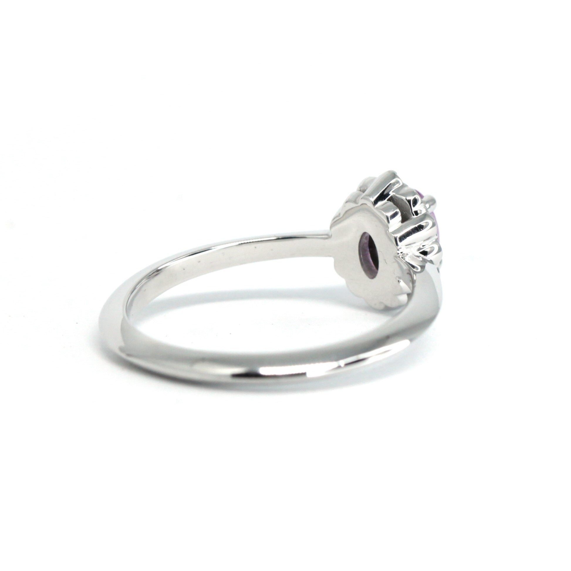 Back view of oval pink sapphire and diamond halo ring in white gold by Bena Jewelry, photographed on a white background, fine bridal jewelry made in Canada.