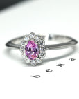 Side view of pink sapphire engagement ring montreal handmade in little italy montreal fine jewelry color gemstone custom made birdal ring pink sapphire and garnet fine gemstone ring montreal fine jeweler