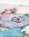 Elegant Diamond Halo Ring featuring a pink sapphire in white gold, custom-made by Bena Jewelry with natural gemstones, perfect for bridal occasions.