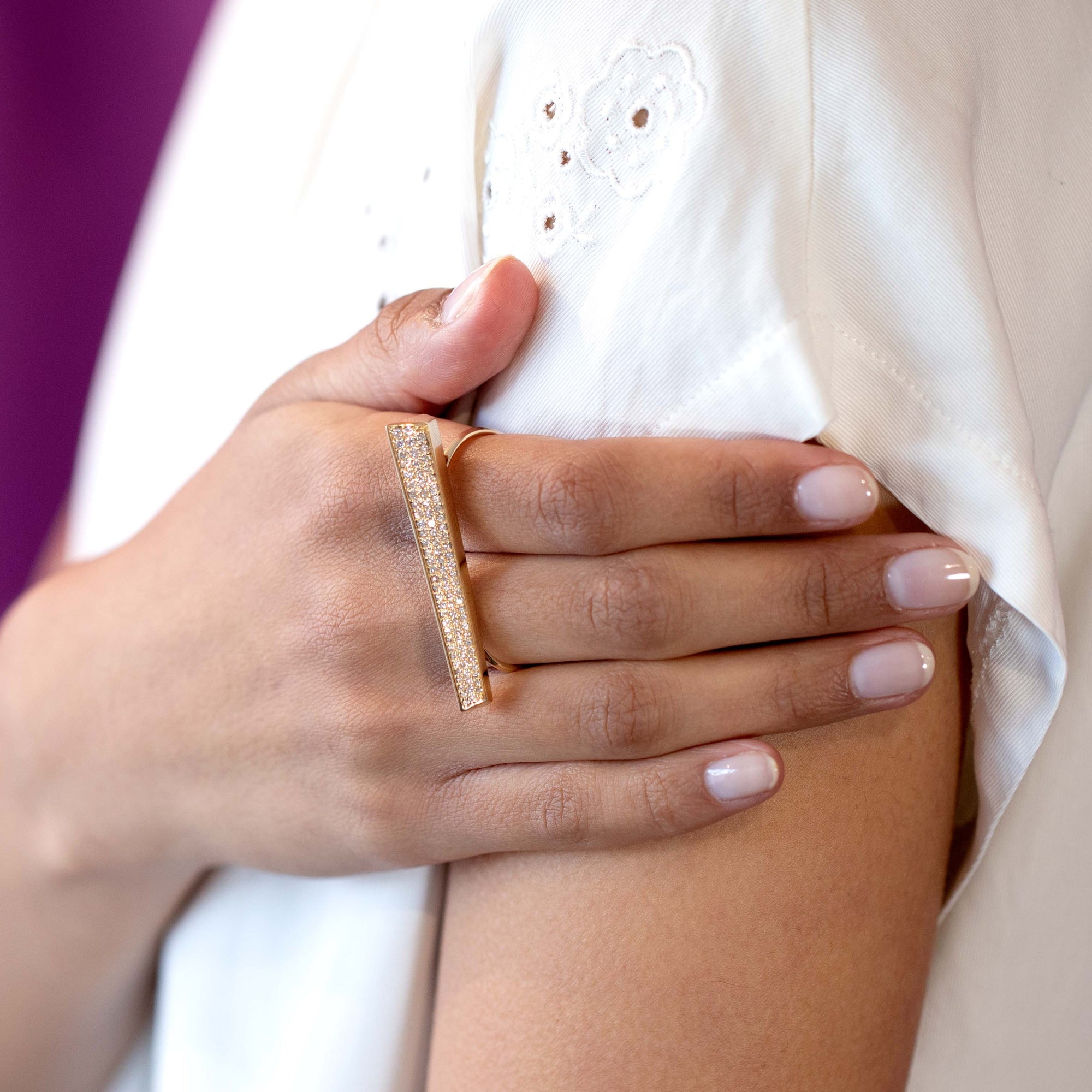 Bena Jewelry, indepandant designer from Monteal, present the close-up of the Diamond Punch ring on the fingers, focusing on the interplay of light on the diamond pavé.