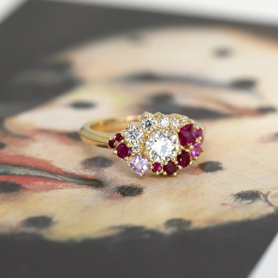 round lab grown diamond ruby yellow gold unique engagement ring custom made in montreal by the designer bena jewelry in collaboration with jeweller ruby mardi bridal jewellery on multi color background