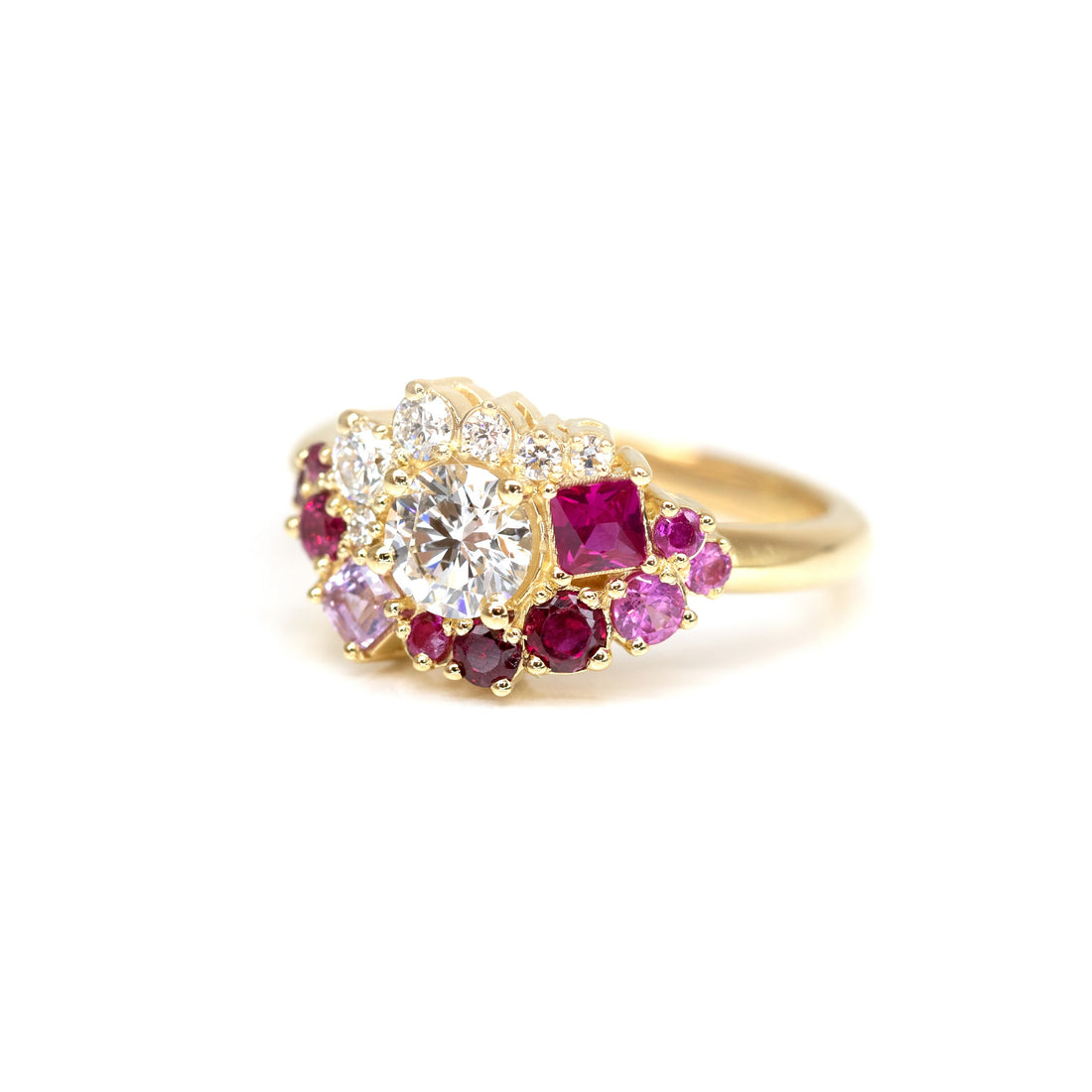 side view of round diamond and princess cut ruby with small pink sapphire custom made unique bridal ring by bena jewelry design in montreal on a white background
