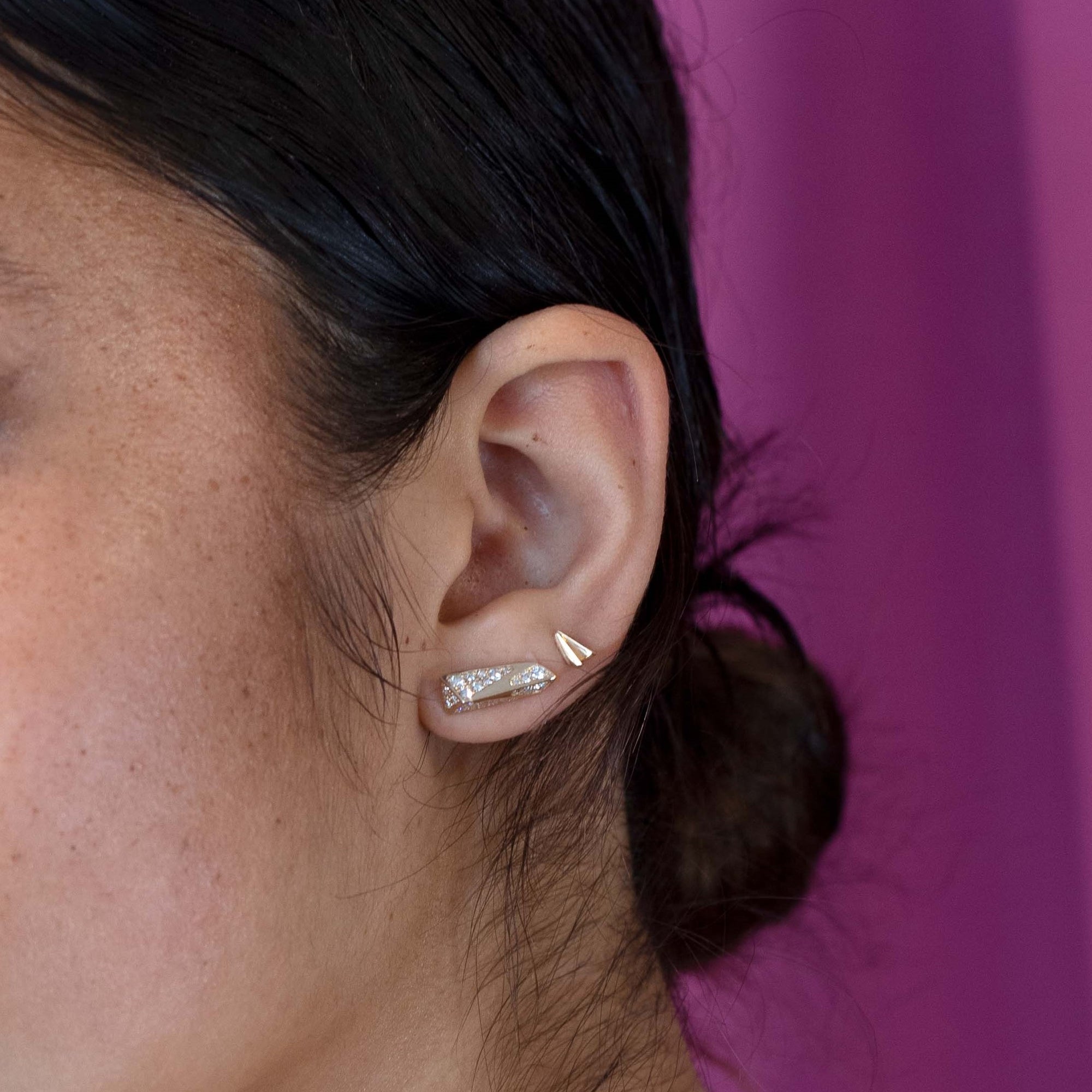 Close up of the studs White Diamond Edges in yellow gold, minimalist and edgy look, crafted by Bena Jewelry.