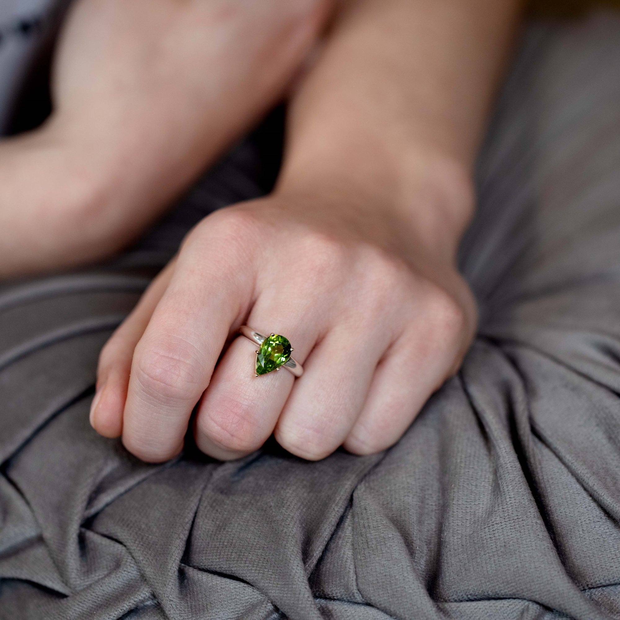 Hand wearing the peridot cocktail ring in natural light – The rich green peridot gemstone catches the light beautifully, creating an eye-catching look.