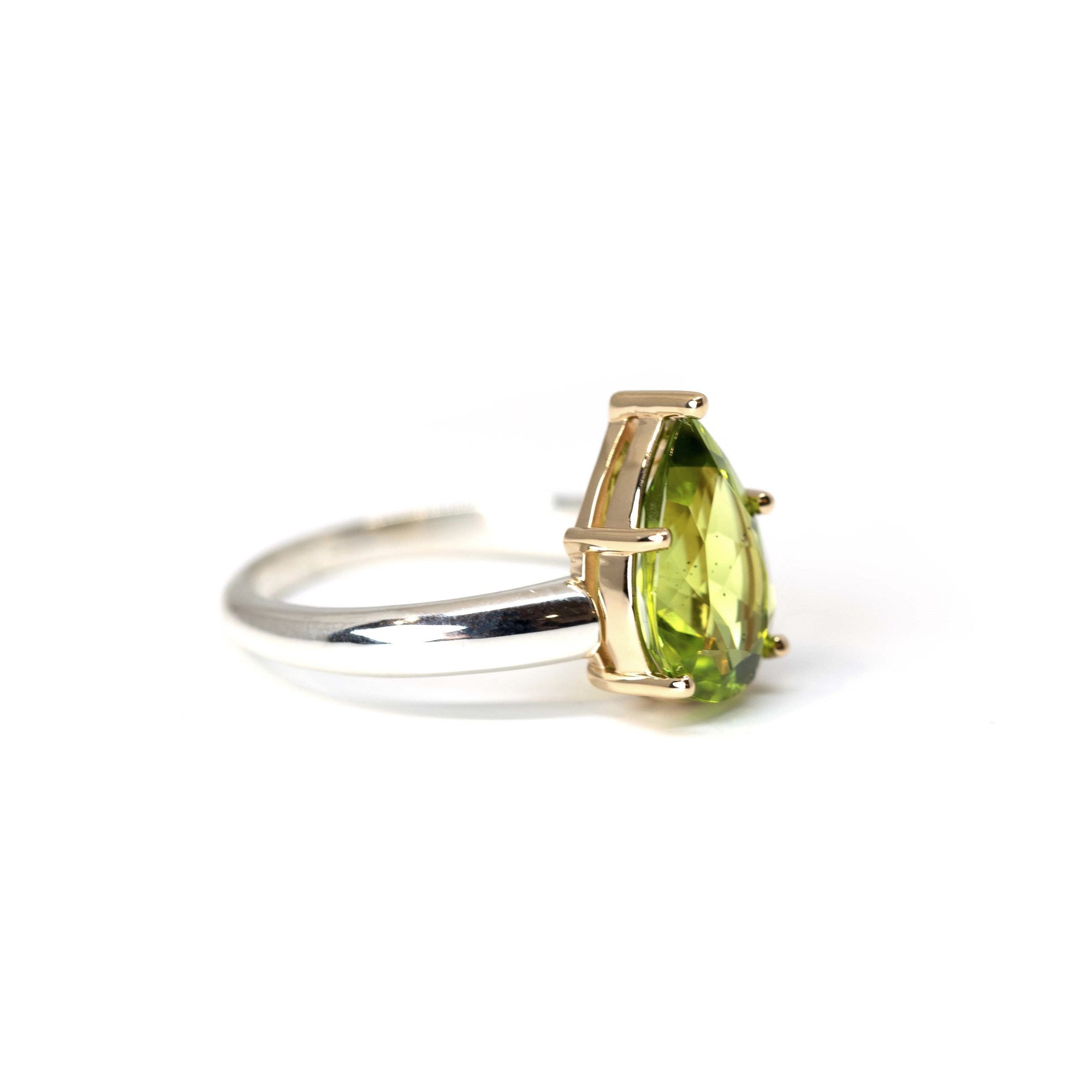 Deep Green Peridot Pear Ring on white background – A bold cocktail ring featuring a deep green pear-shaped peridot from Pakistan, designed by Bena Jewelry in Montreal.