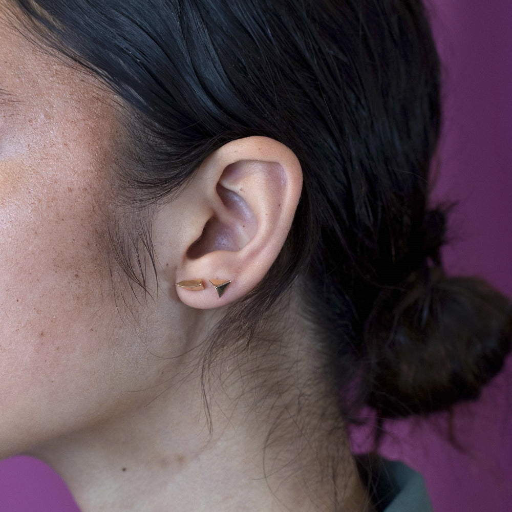 Girl wearings sharp and modern: the Brace Studs in yellow gold bring edgy sophistication to any look. Indenpandant designer jewelry, from Canada.