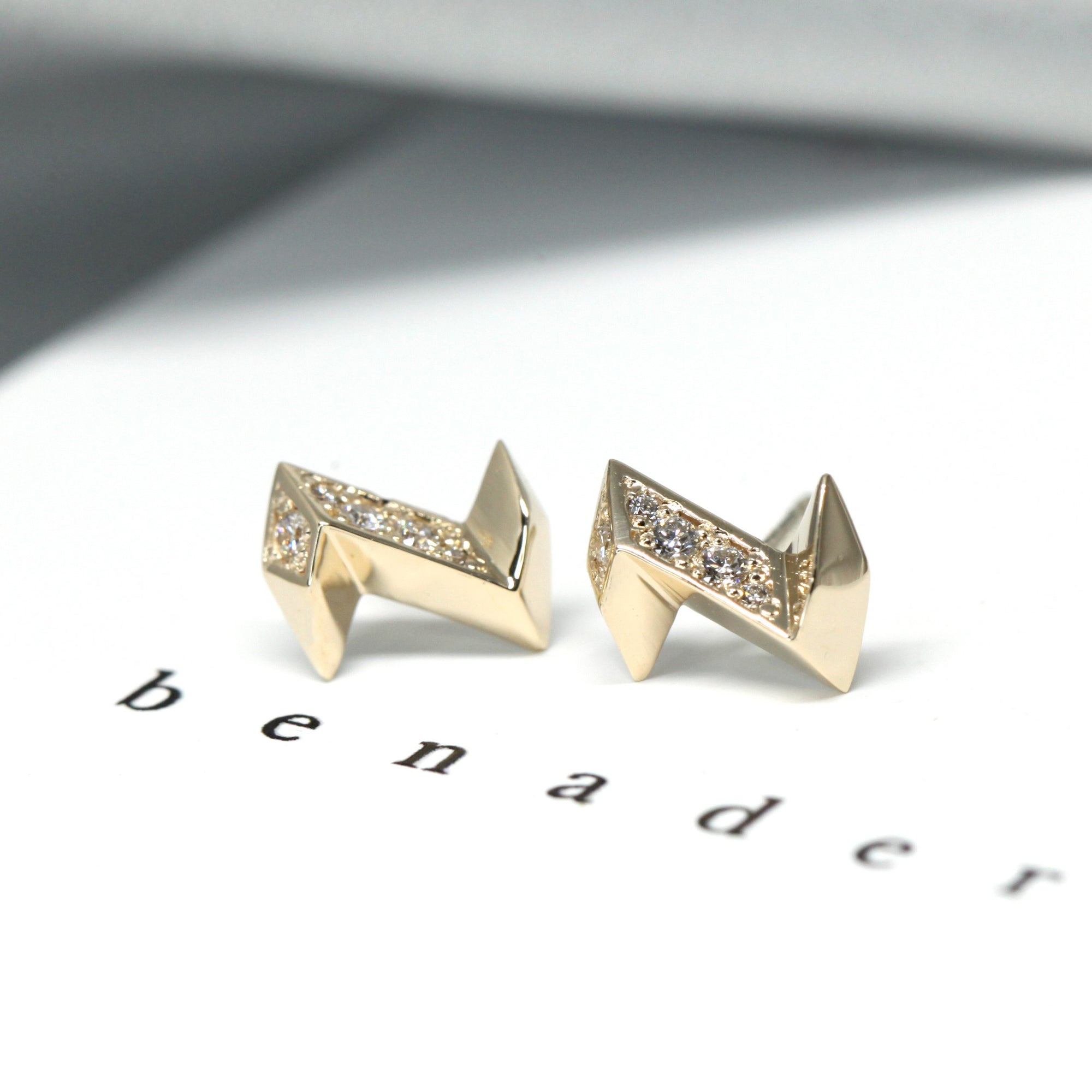 Electric Diamond Studs sparkling against a grey background, edgy design by Bena Jewelry, Montreal.