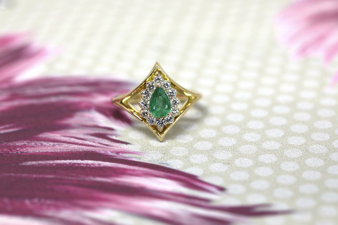 custom made pear shape emerald and white diamond halo bridal ring yellow gold bena jewelry designer montreal