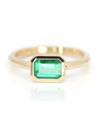 emerald colored gemstone bezel setting in yellow gold custom made in montreal by bena jewelry on white background