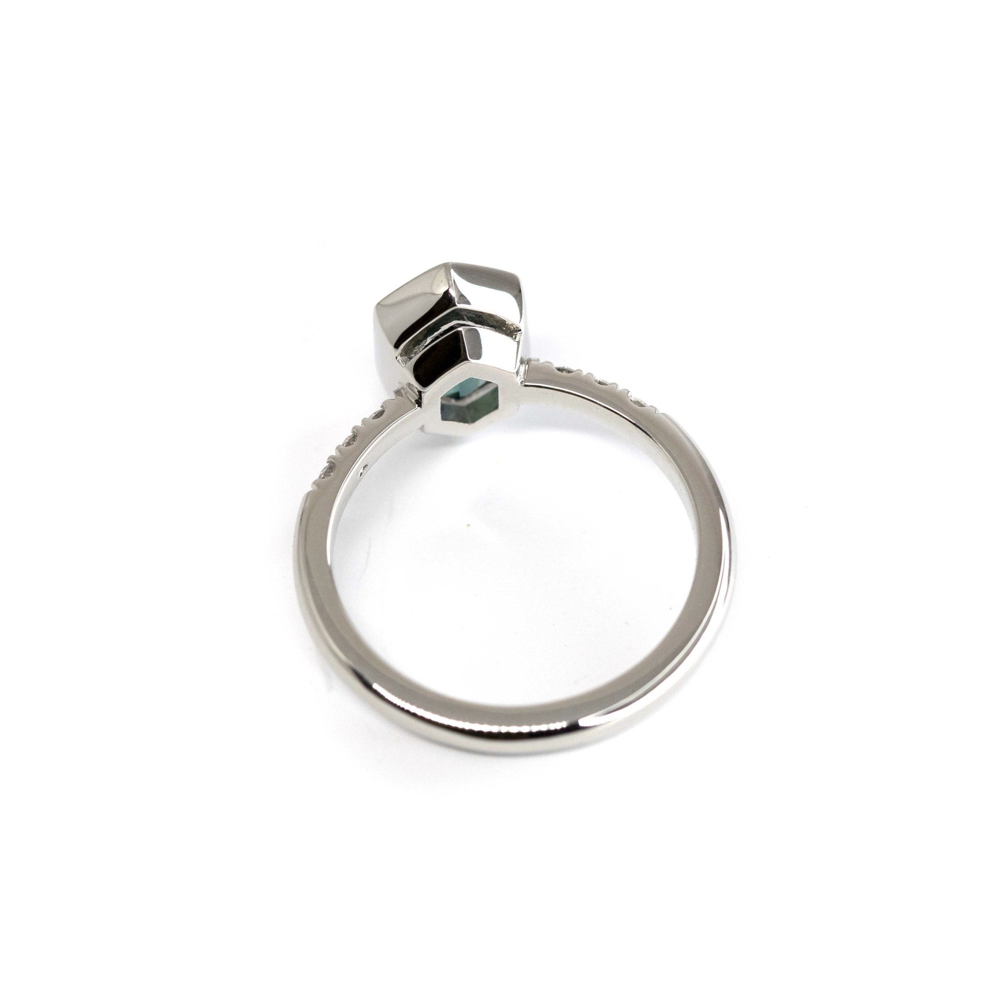 Back view of sapphire ring – Sleek platinum band highlighting the deep blue brilliance of the hexagonal sapphire and sparkling side diamonds. A fine jewelry design by Bena Jewelry.