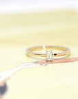 front view of diamond ring with small baguette lab grown custom made in montreal on yellow background