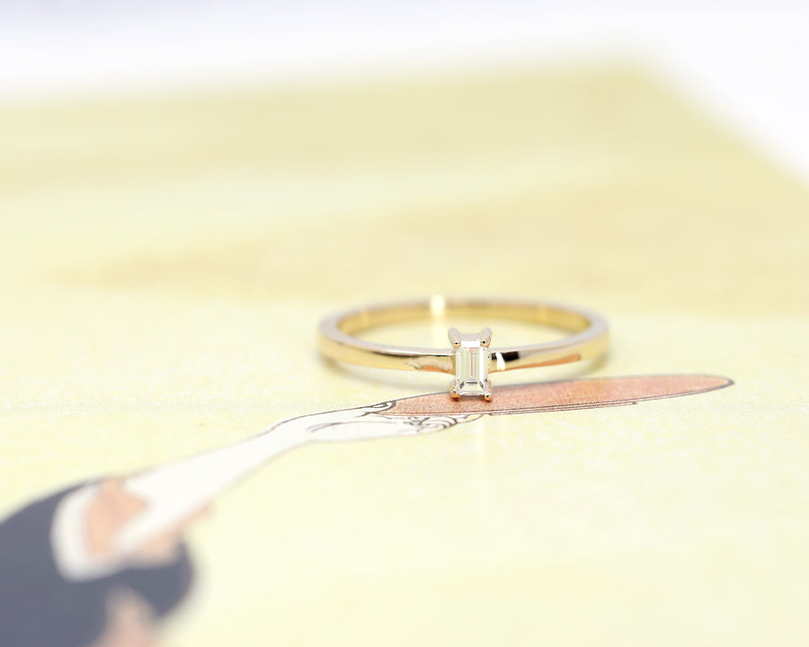 front view of diamond ring with small baguette lab grown custom made in montreal on yellow background