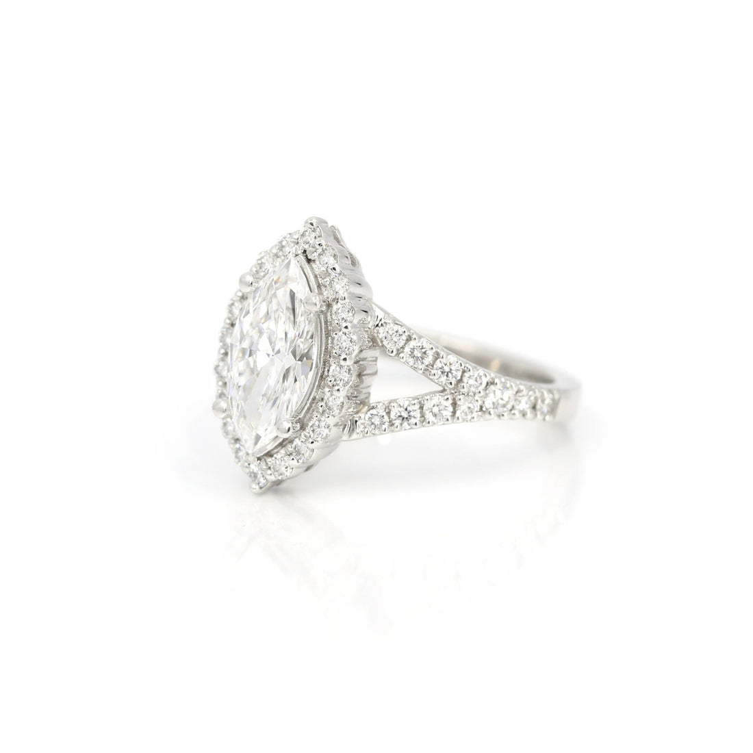 side view of marquise shape lab grown diamond engagement ring custom made in montreal diamonds halo and band white gold fine bena jewelry montreal on white background