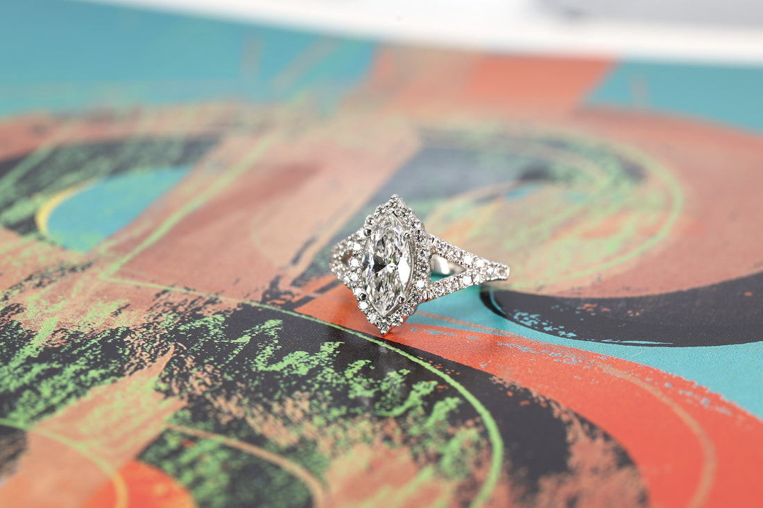 side view of marquise shape lag grown diamond and halo custom made engagement ring montreal by bena jewelry on multi color background