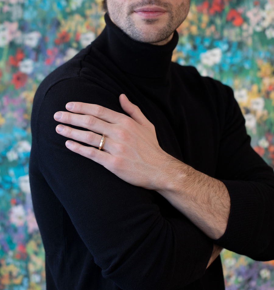 men wearing a chiseled men ring custom made in montreal by bena jewelry designer on multi color background