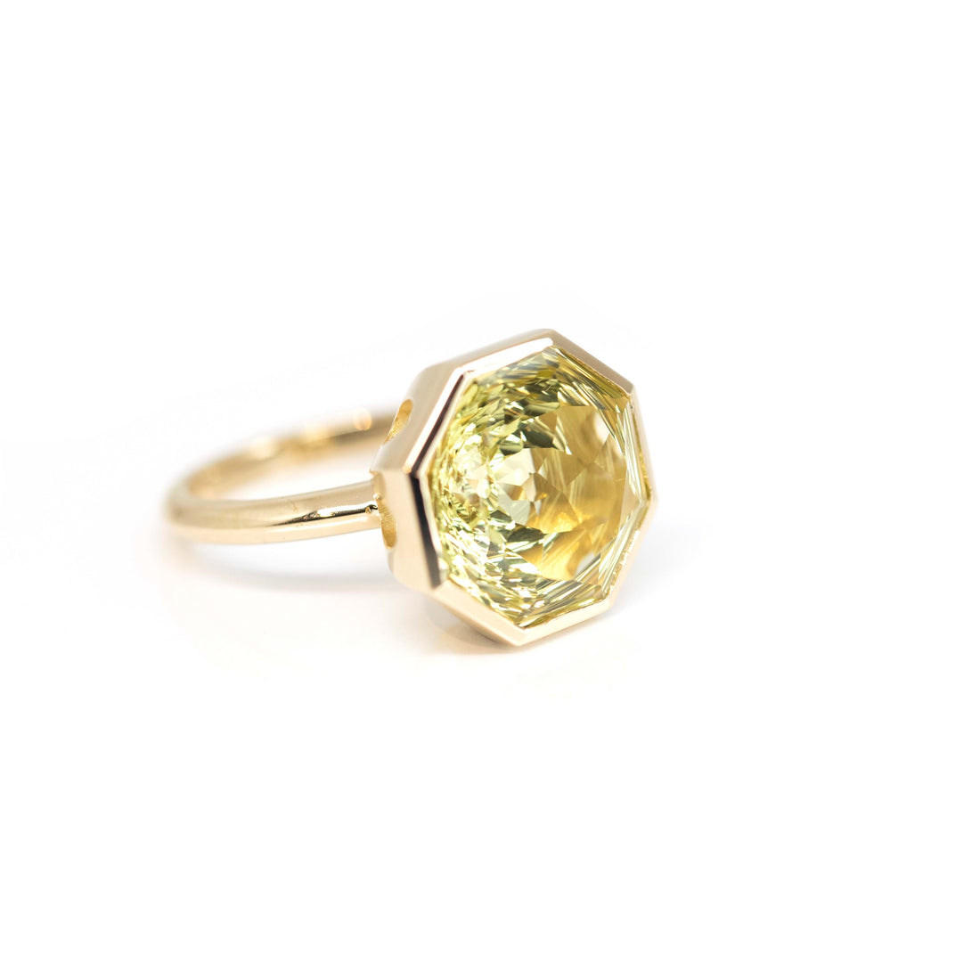 side view of custom made lemon quartz statement designer ring made by bena jewelry on a white backgroubd