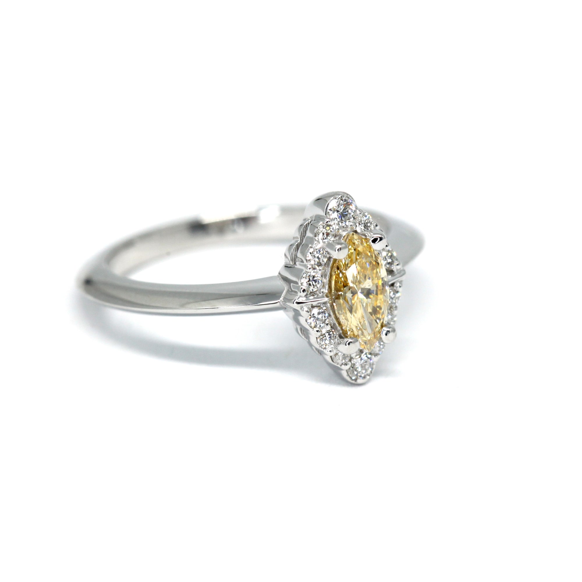 Close-up of the yellow marquise diamond engagement ring, showcasing its halo setting and elegant design. Made in Canada.