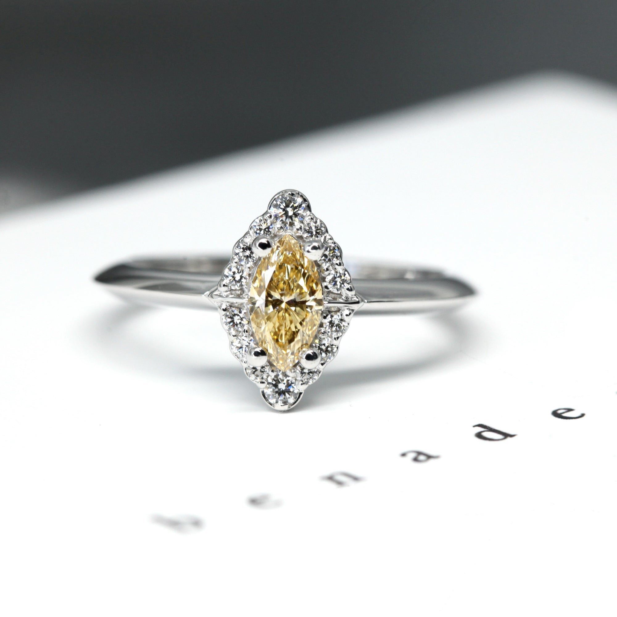 The Aura Ring, a custom-made vintage-inspired engagement ring, beautifully displayed on a soft-colored background.
