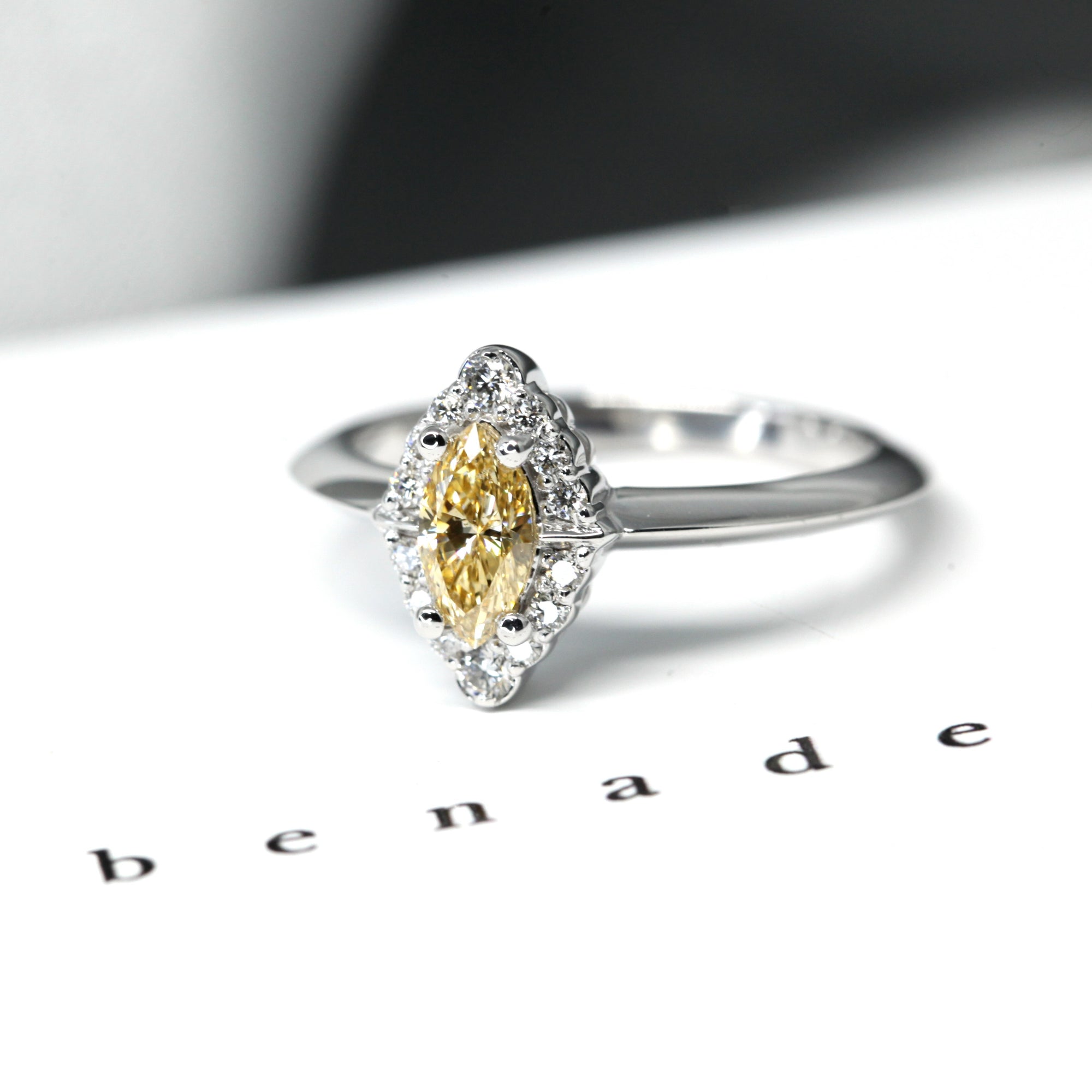 Detailed view of the marquise-cut yellow diamond and halo, an elegant engagement ring made in Montreal, Canada.
