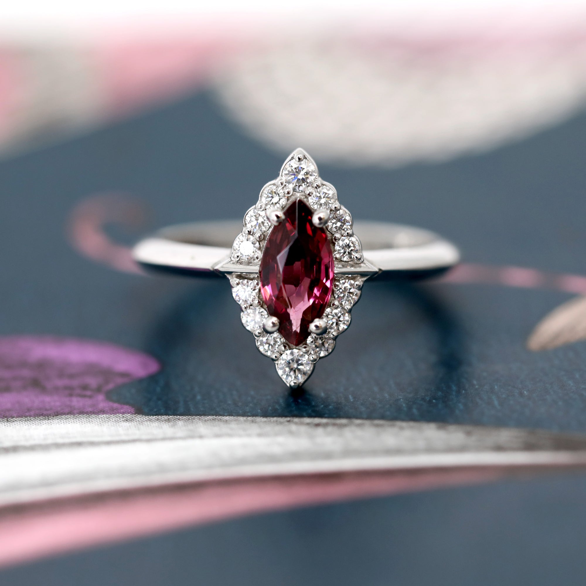 Front view of edgy marquise red gemstone bridal white gold marquise shape gold ring bena jewelry montreal custom made birdal jewelry small white diamonds custom made little italy fine jewelry designer natural rhodolite garnet gems