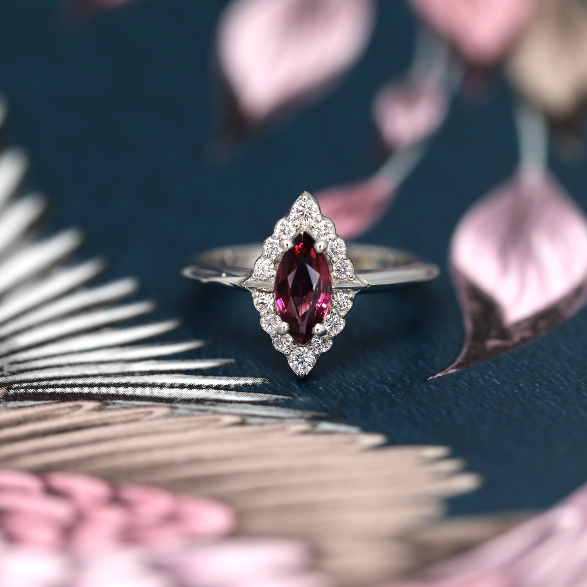 Front view of edgy diamonds ring marquise shape red gemstone garnet precisous fine jewelry white diamonds engagement ring white gold ring bena jewelry montreal made in canada custom fine jewrelry
