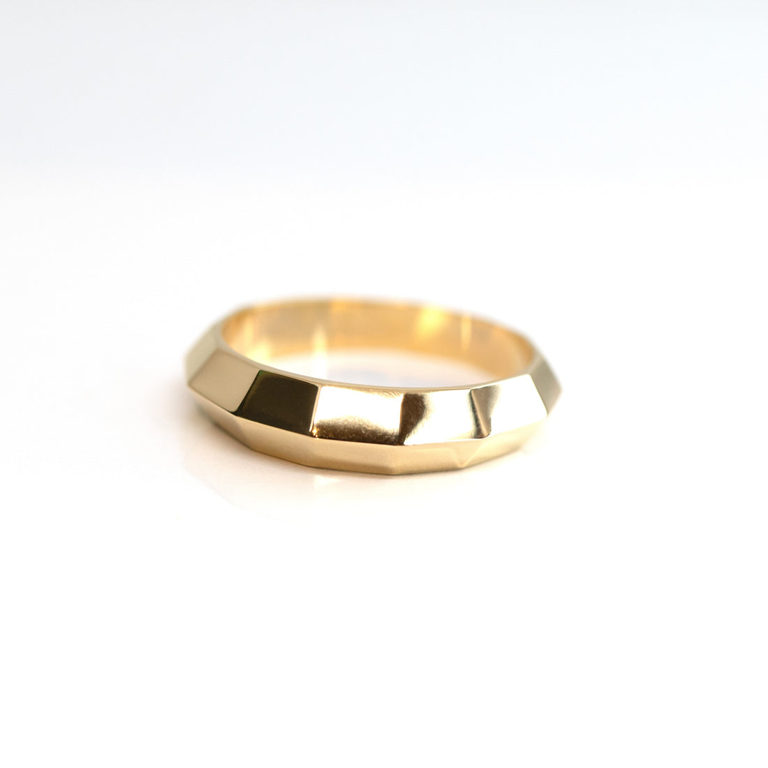 front view of men gold edgy custom made ring in montreal chiseled collection by bena jewely designer in collaboration with boutique ruby mardi best jeweler in canada on white background