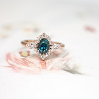 bena jewelry custom made oval shape blue sapphire and diamond custom made ring on a multi color background