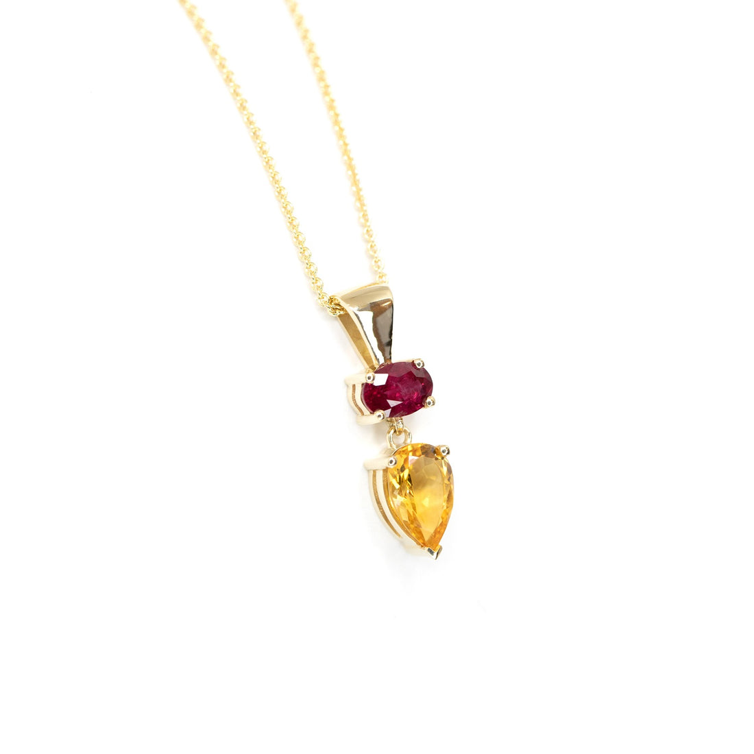 colored gemstone custom made jewelry in montreal made with citrine pear shape and oval ruby gemstone by bena jewelry on a white background