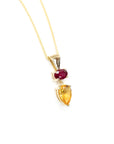 colored gemstone custom made jewelry in montreal made with citrine pear shape and oval ruby gemstone by bena jewelry on a white background