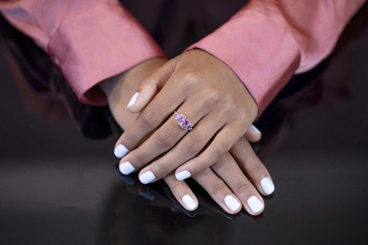 A close-up of the Avalanche Pink Sapphire Ring worn, showcasing its artistic design, vibrant gemstones, and yellow gold setting. Made by Bena Jewelry in Montreal, Canada.