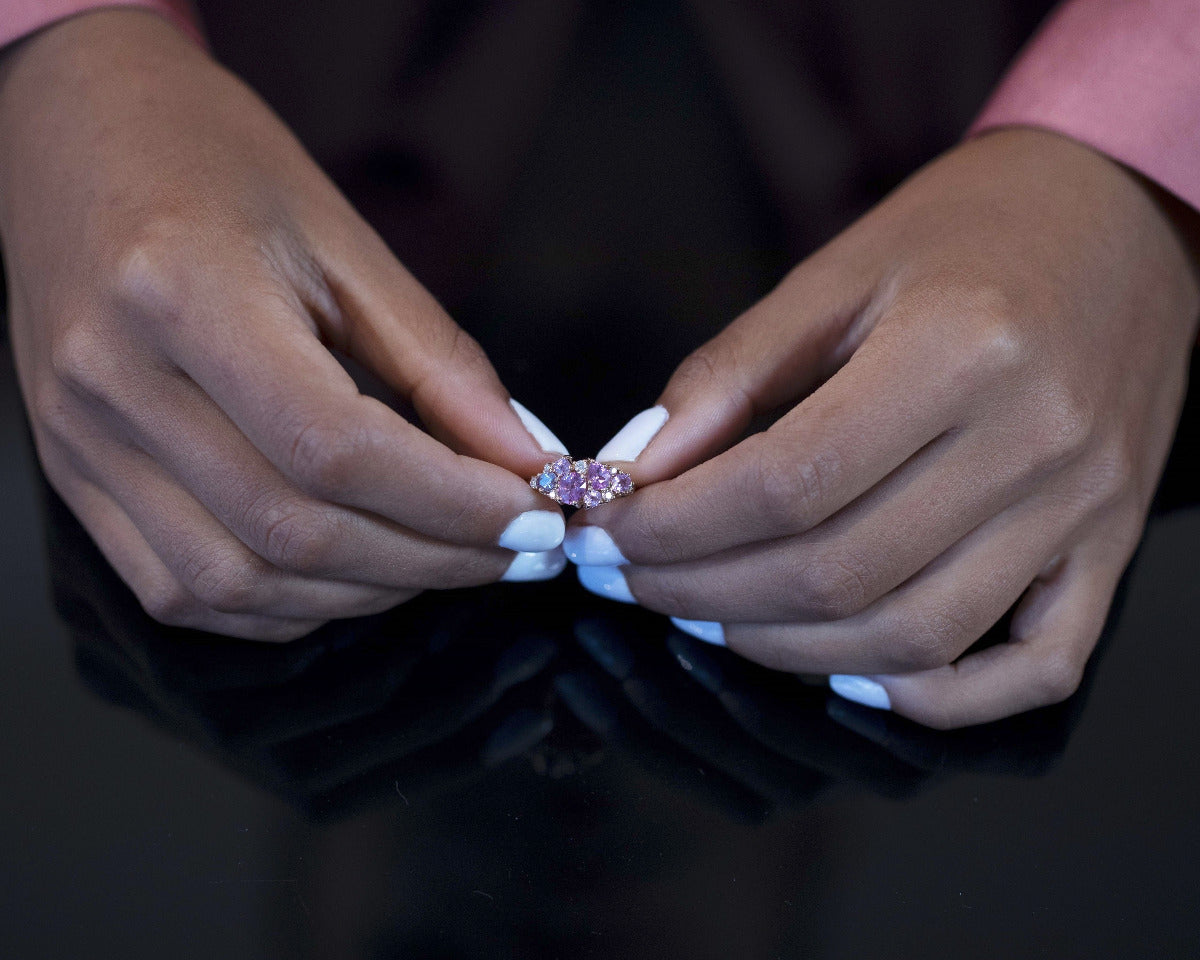  A model wearing the Avalanche Pink Sapphire Ring in an elegant setting, emphasizing its vibrant gemstones and luxurious design. Custom-made by Bena Jewelry in Montreal, Canada.