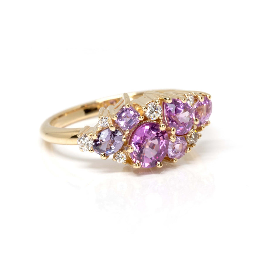 side view of avalanche pink purple oval shape and pear shape natural sapphire gemstone and diamond engagement ring on white background