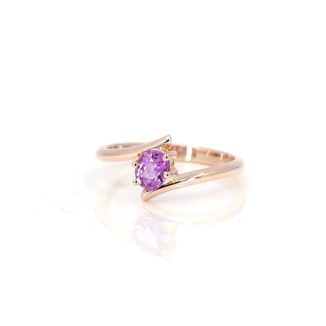 front view of oval shape pink sapphire kink ring custom made in rose gold in montreal by bena jewelry desgin white background