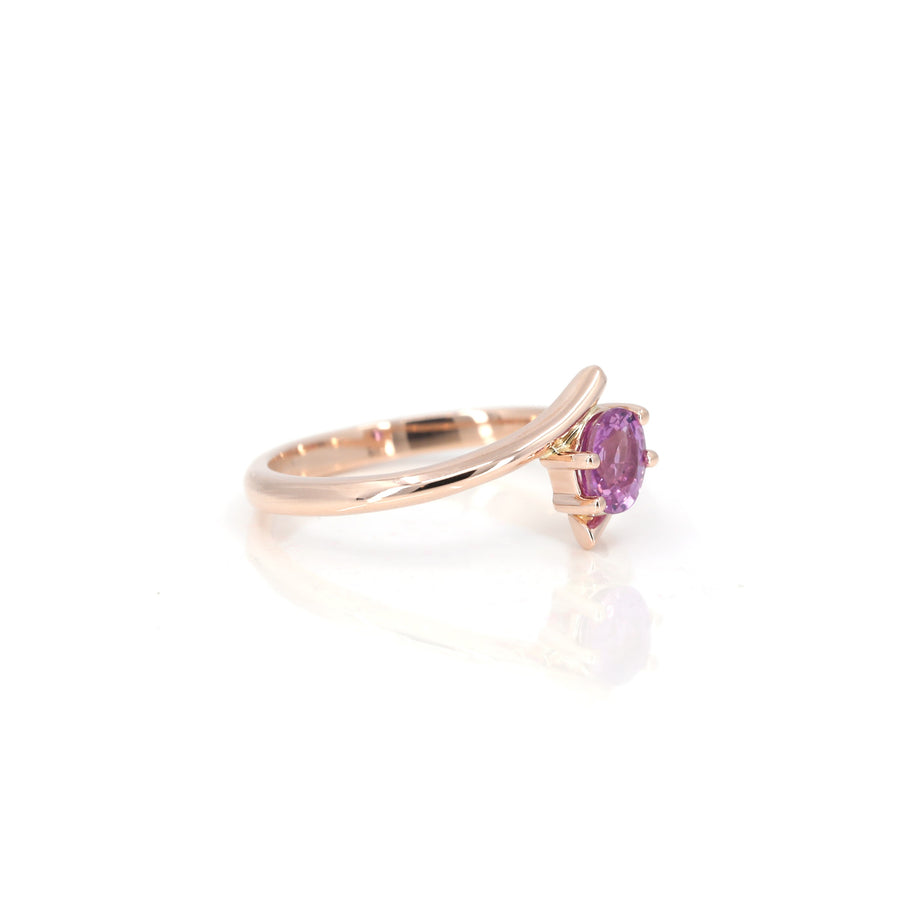 side view of oval shape pink sapphire rose gold twist band kink ring made in montreal by bena jewelry designer on white background