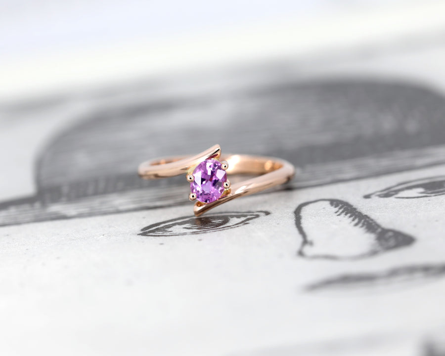 front view of bena jewelry pink sapphire rose gold kink ring edgy engagement ring on balck and white background