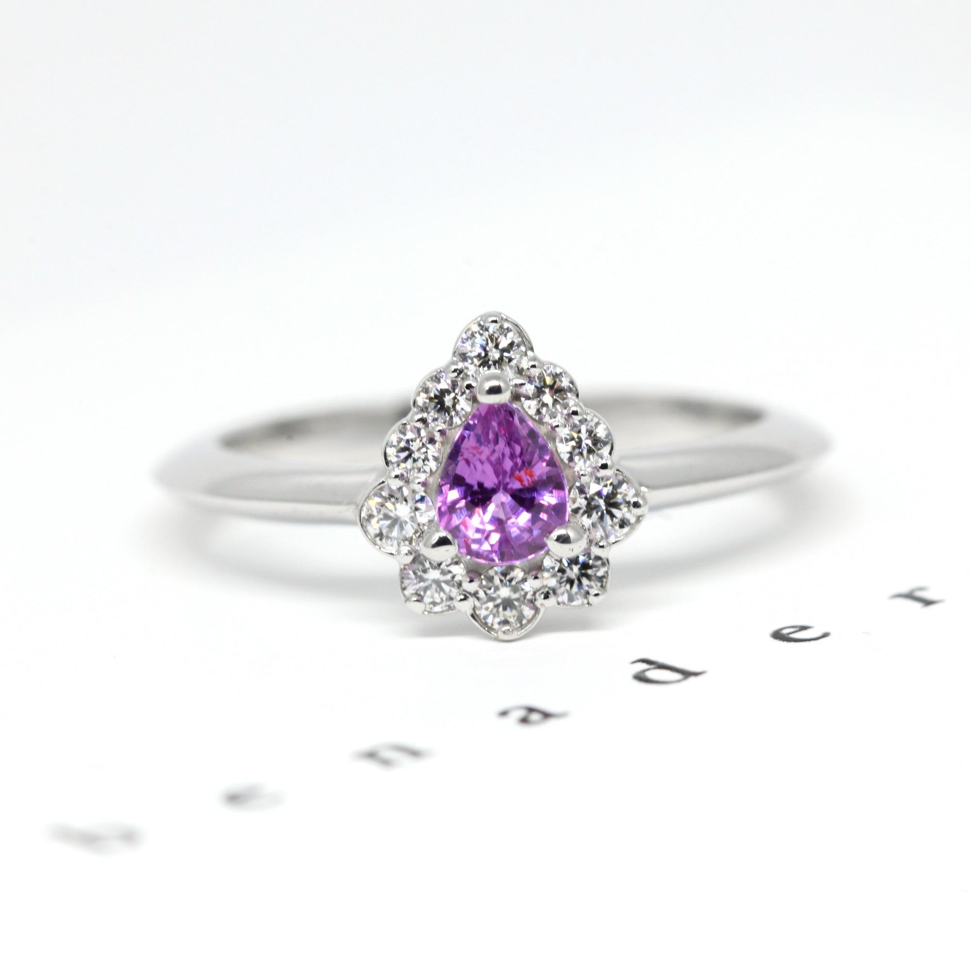 Side view of the Aura ring, revealing the intricate white gold setting that enhances the brilliance of the sapphire and diamonds. A refined creation by Bena Jewelry, made in Montreal.