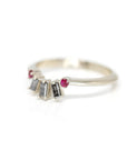 side view of salt and pepper diamond bagette and round ruby on white gold band made in montreal by bena jewelry designer on a white background