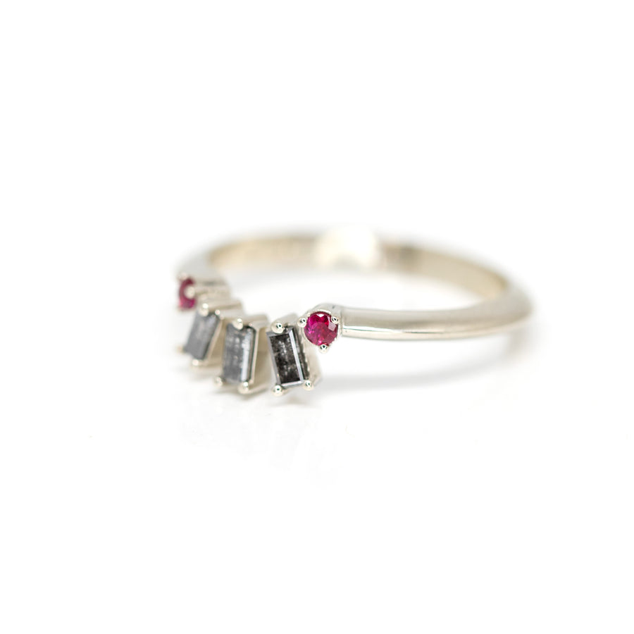 side view of salt and pepper diamond bagette and round ruby on white gold band made in montreal by bena jewelry designer on a white background