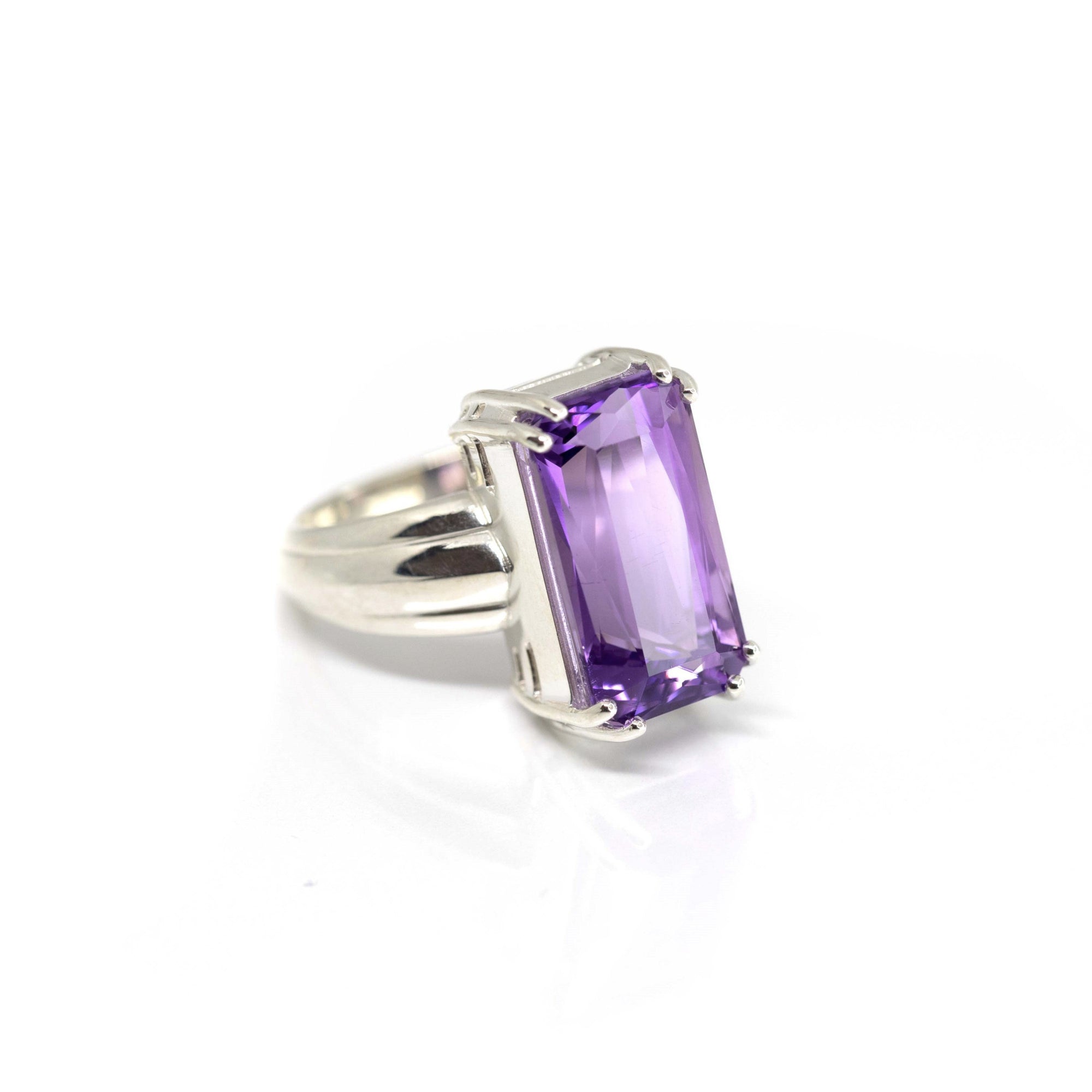 Top-down view of bold amethyst ring – The faceted scissor-cut amethyst catches the light beautifully, creating a dramatic and elegant look.