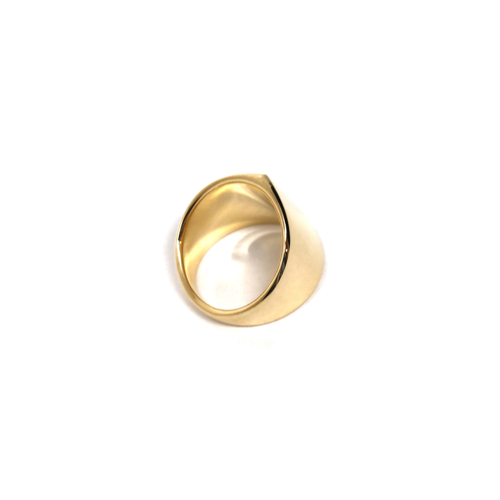 Angled shot of gold ring – A bold, structured ring with a smooth, high-polish gold surface, perfect for those who love modern fine jewelry.