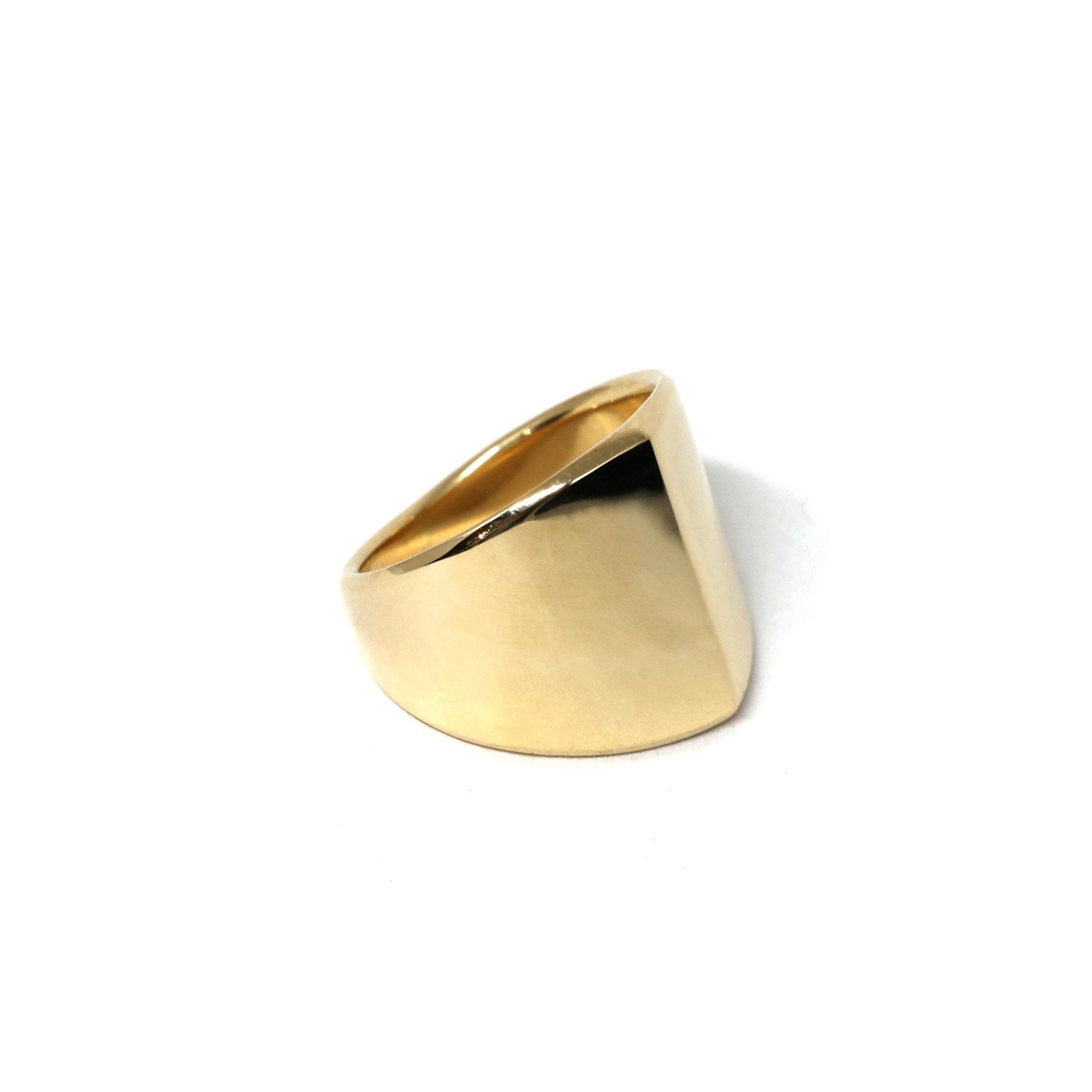 Boxy Gold Ring on soft-toned background – The sleek edges and high-polish gold contrast beautifully, enhancing the minimalist design.