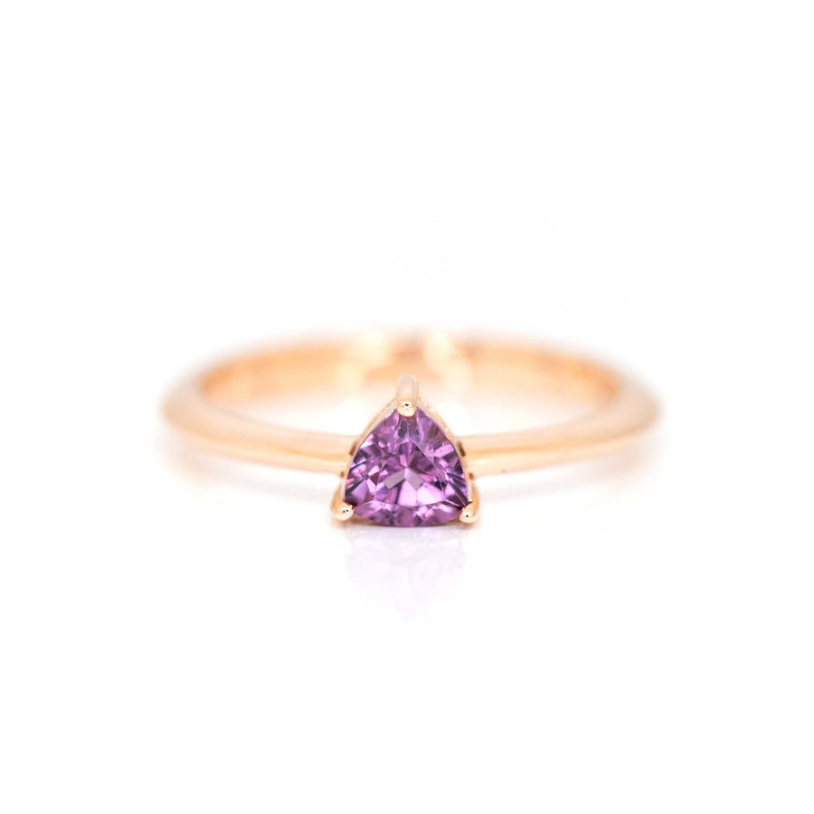 this bridal ring is made with a trillion shape purple rhodolite garnet by bena jewelry designer on a white back ground