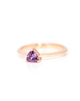 trillion shape purple sapphire rose gold ring on a white background